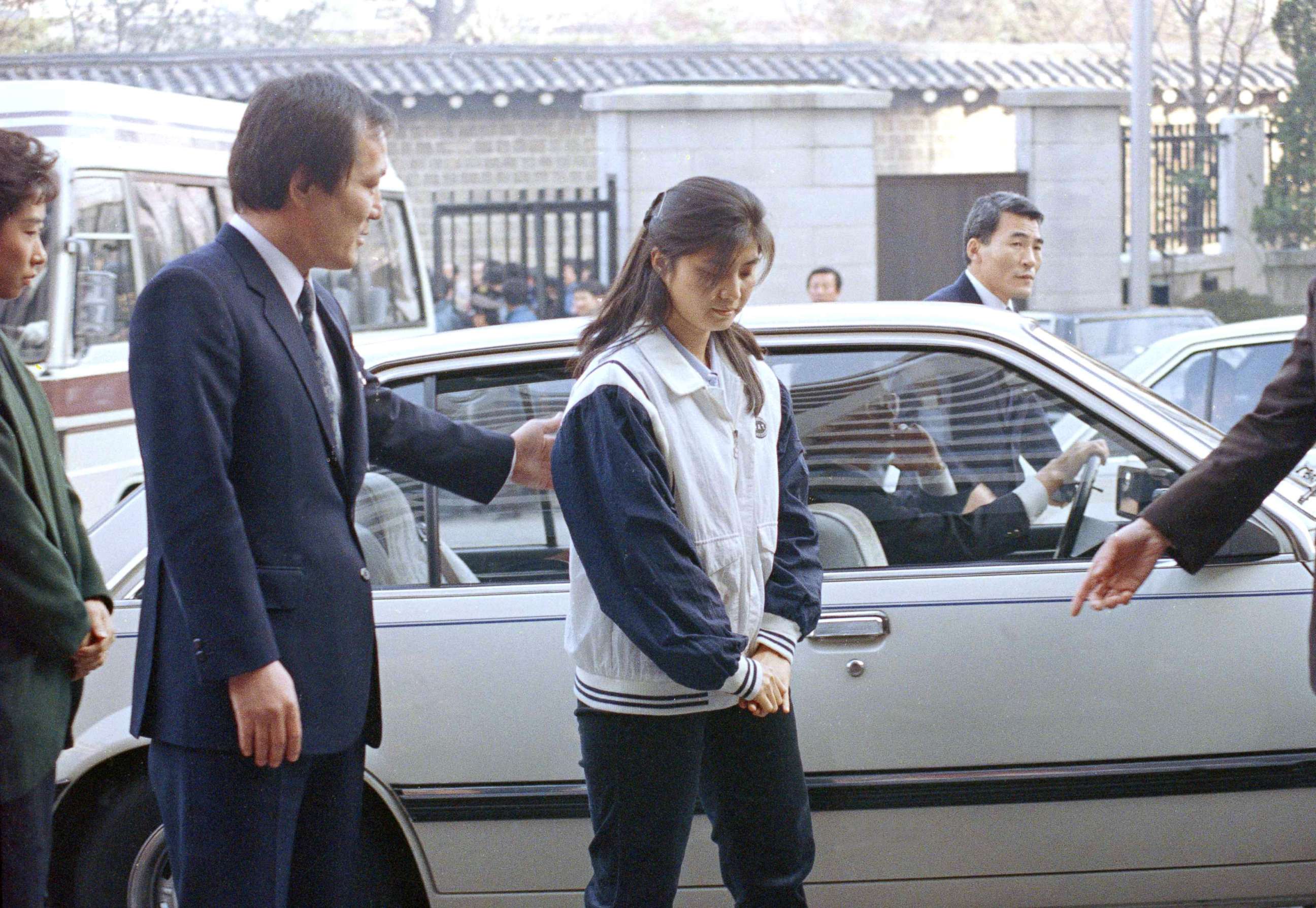 PHOTO: A security officer leads Kim Hyon-hui into the prosecutor's office in Seoul, South Korea, Dec. 2, 1988, to answer questions about the Nov. 1987 bombing of a South Korean airliner resulting in the deaths of all 115 persons on board. 