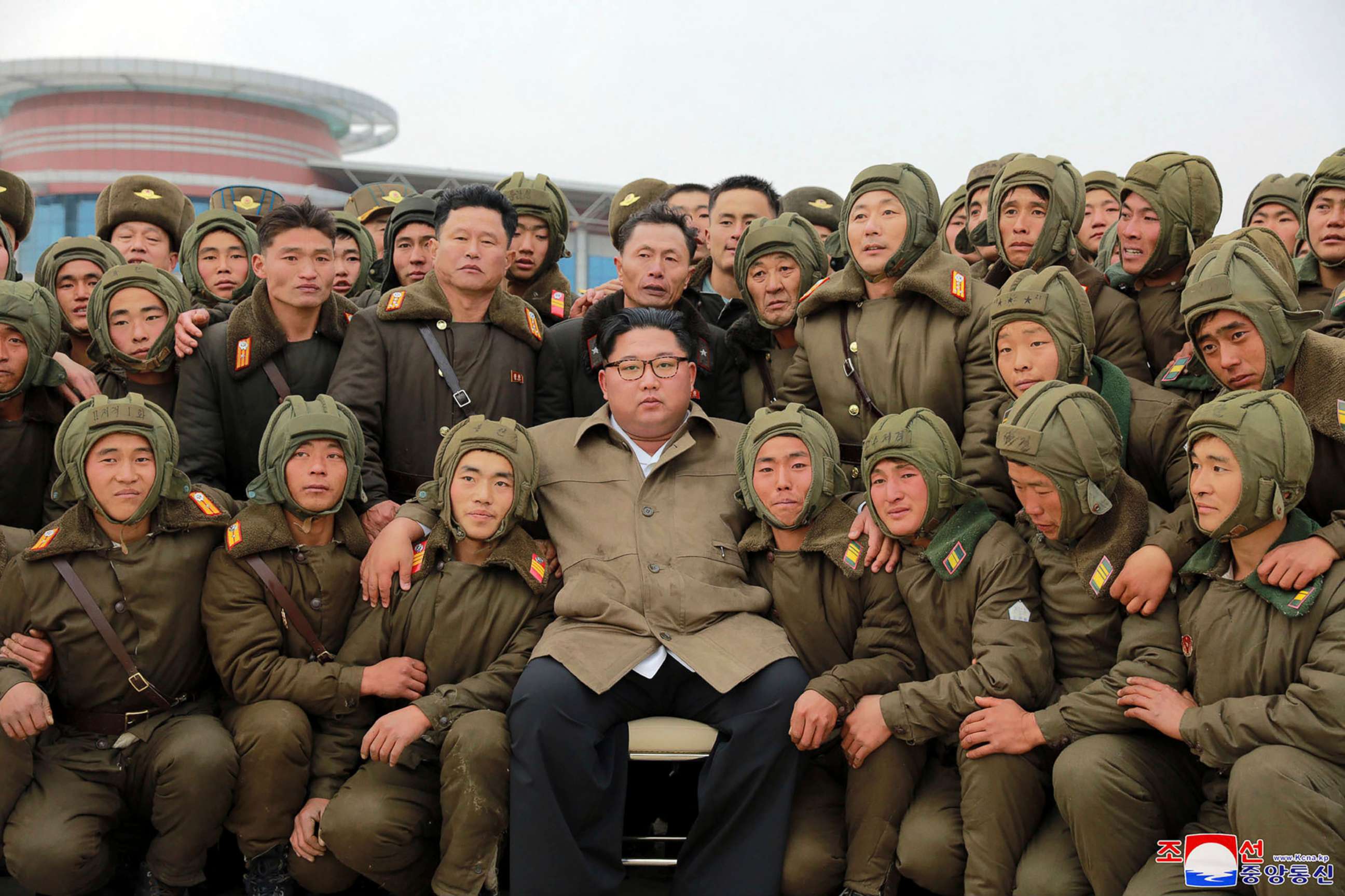 PHOTO: In this undated photo provided on Monday, Nov. 18, 2019, by the North Korean government, Kim Jong Un, center, poses with North Korean air force sharpshooters and soldiers for a photo at an unknown location in North Korea.