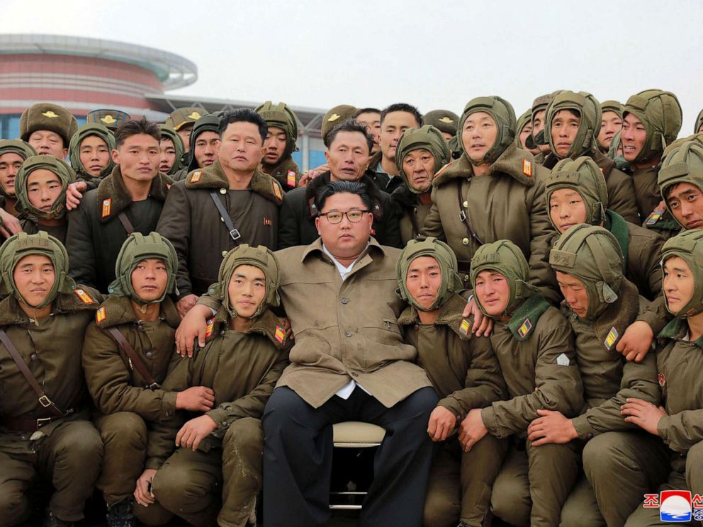 PHOTO: In this undated photo provided on Monday, Nov. 18, 2019, by the North Korean government, Kim Jong Un, center, poses with North Korean air force sharpshooters and soldiers for a photo at an unknown location in North Korea.