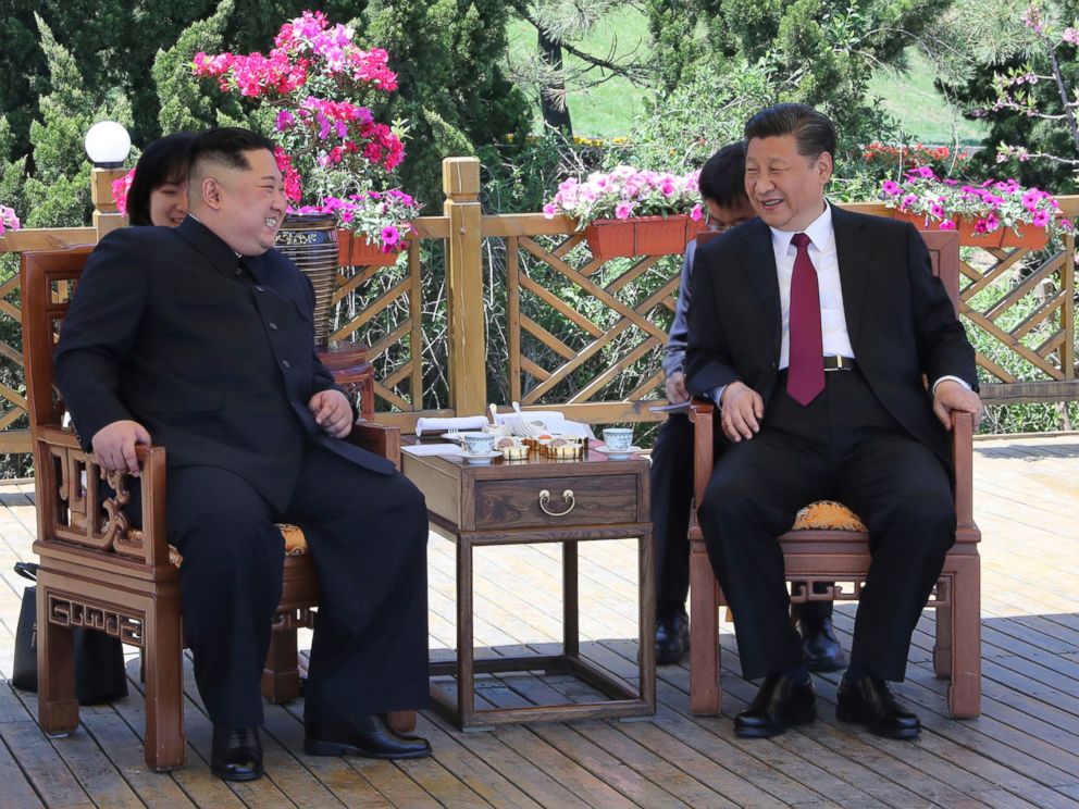 PHOTO: North Korean leader Kim Jong Un and Chinese President Xi Jinping walk during a meeting in Dalian in northeastern China's Liaoning Province.