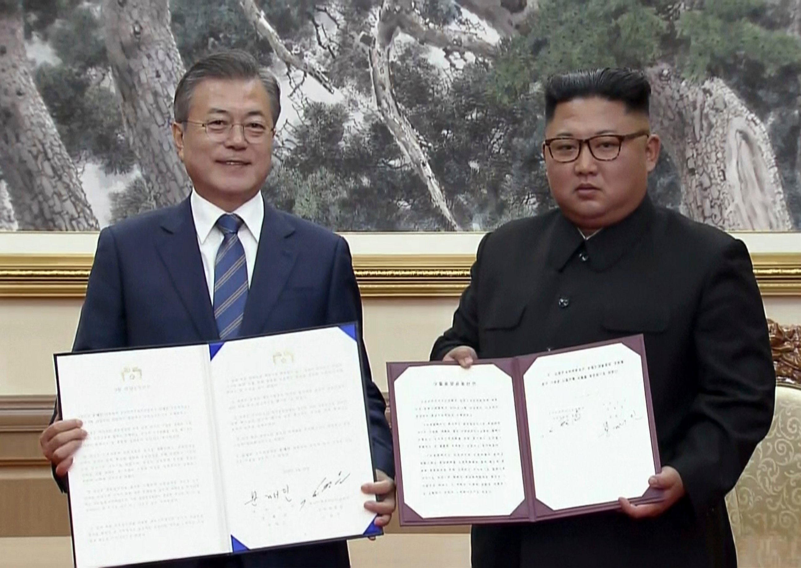 PHOTO: In this image made from video provided by Korea Broadcasting System (KBS), South Korean President Moon Jae-in, left, and North Korean leader Kim Jong Un pose after signing documents in Pyongyang, North Korea Wednesday, Sept. 19, 2018.