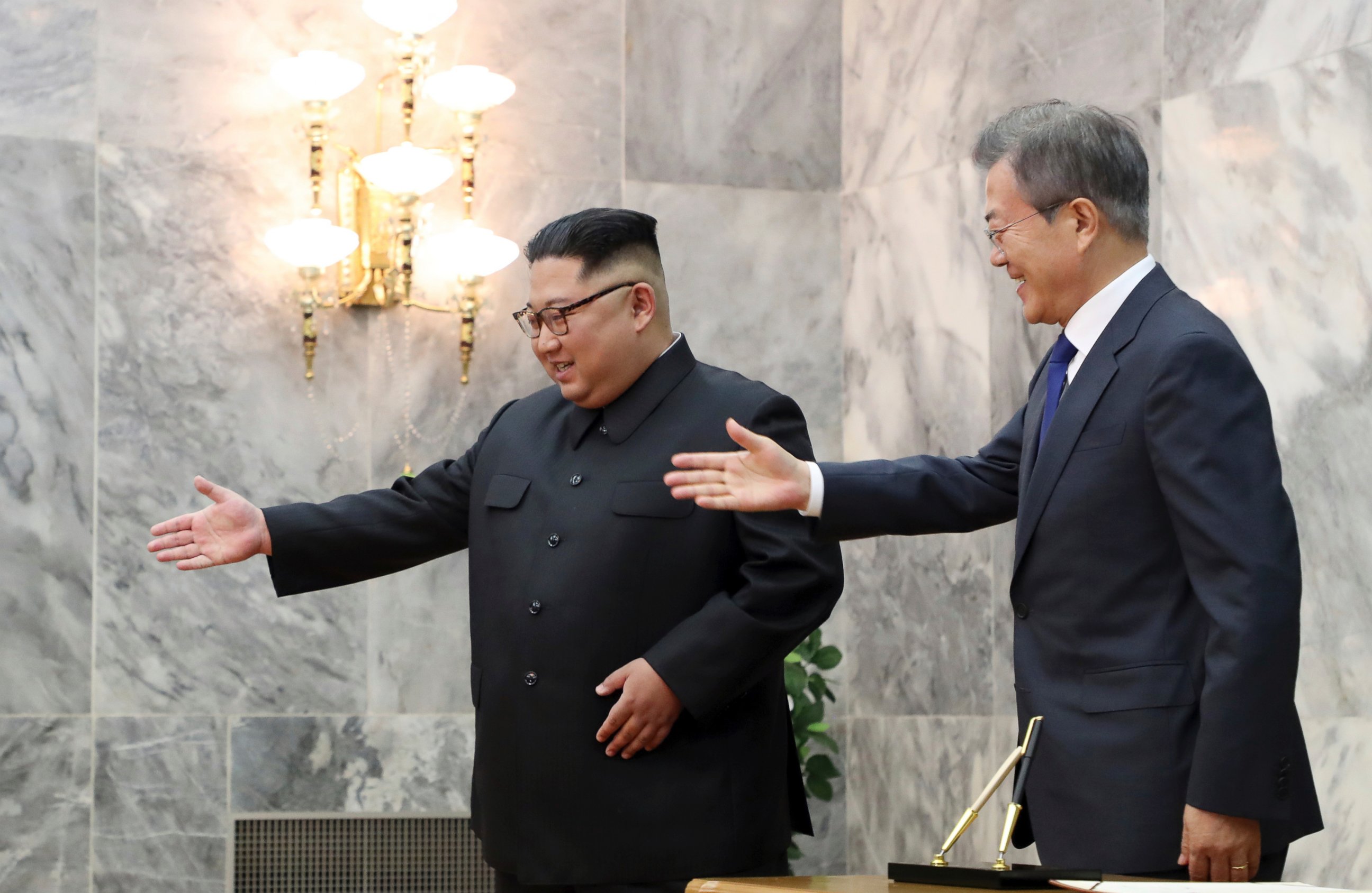 In this May 26, 2018 photo provided by South Korea Presidential Blue House via Yonhap News Agency, South Korean President Moon Jae-in, right, is guided by North Korean leader Kim Jong Un, left, at the northern side of Panmunjom in North Korea.