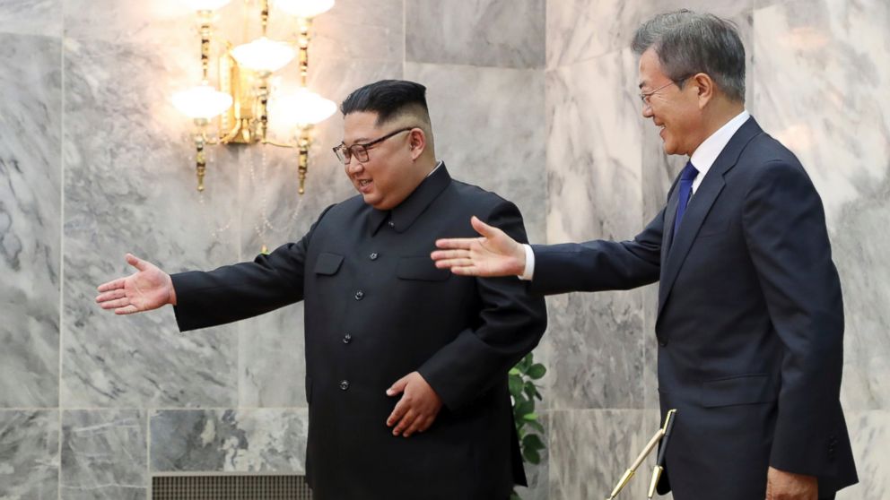 In this May 26, 2018 photo provided by South Korea Presidential Blue House via Yonhap News Agency, South Korean President Moon Jae-in, right, is guided by North Korean leader Kim Jong Un, left, at the northern side of Panmunjom in North Korea.