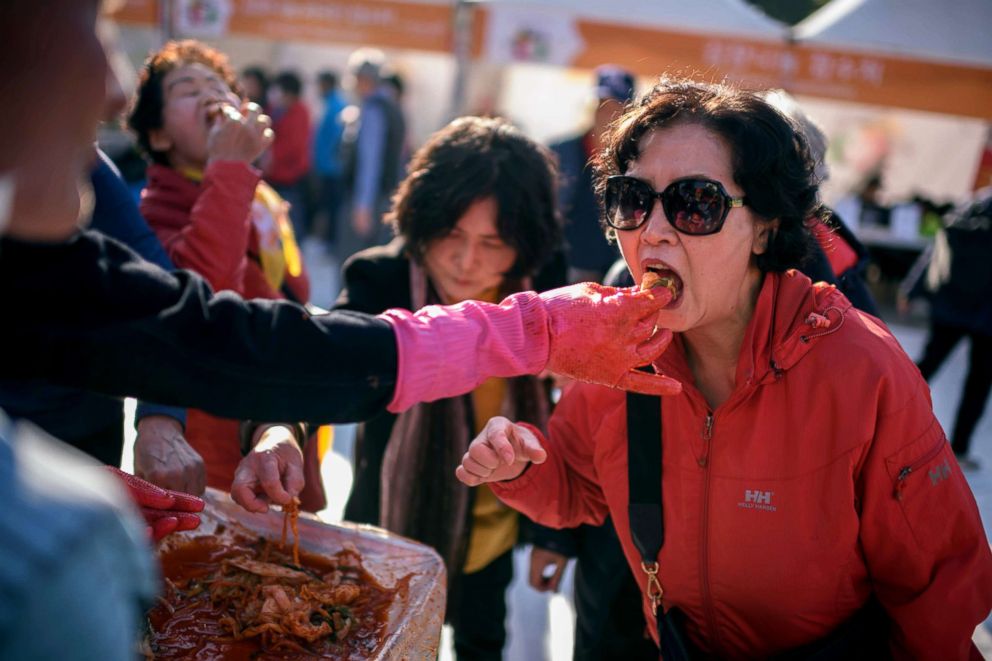 PHOTO: A spectator eats kimchi during a kimchi making festival in Seoul, Nov. 2, 2018.