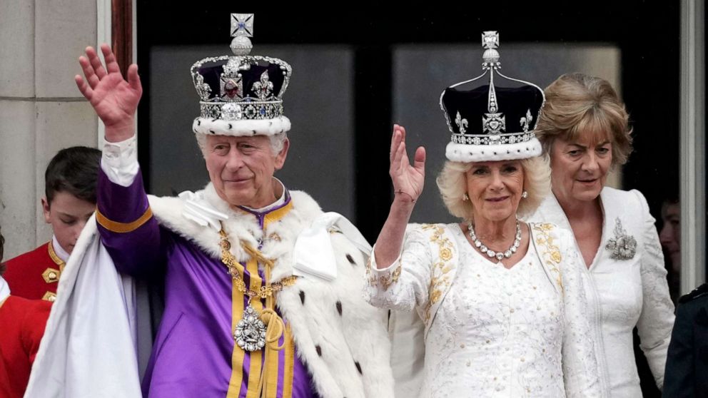 PHOTO: King Charles III and Queen Camilla can be seen on the Buckingham Palace balcony ahead of the flypast during the Coronation of King Charles III and Queen Camilla, May 06, 2023 in London.