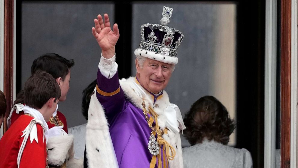 PHOTO: King Charles III waves from The Buckingham Palace balcony during the Coronation of King Charles III and Queen Camilla, May 06, 2023 in London.