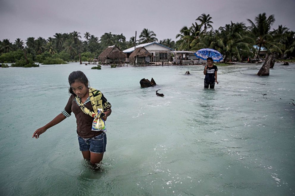 PHOTO: A young woman wades through floodwaters to her village Eita, Kiribati, Sept. 29, 2015.