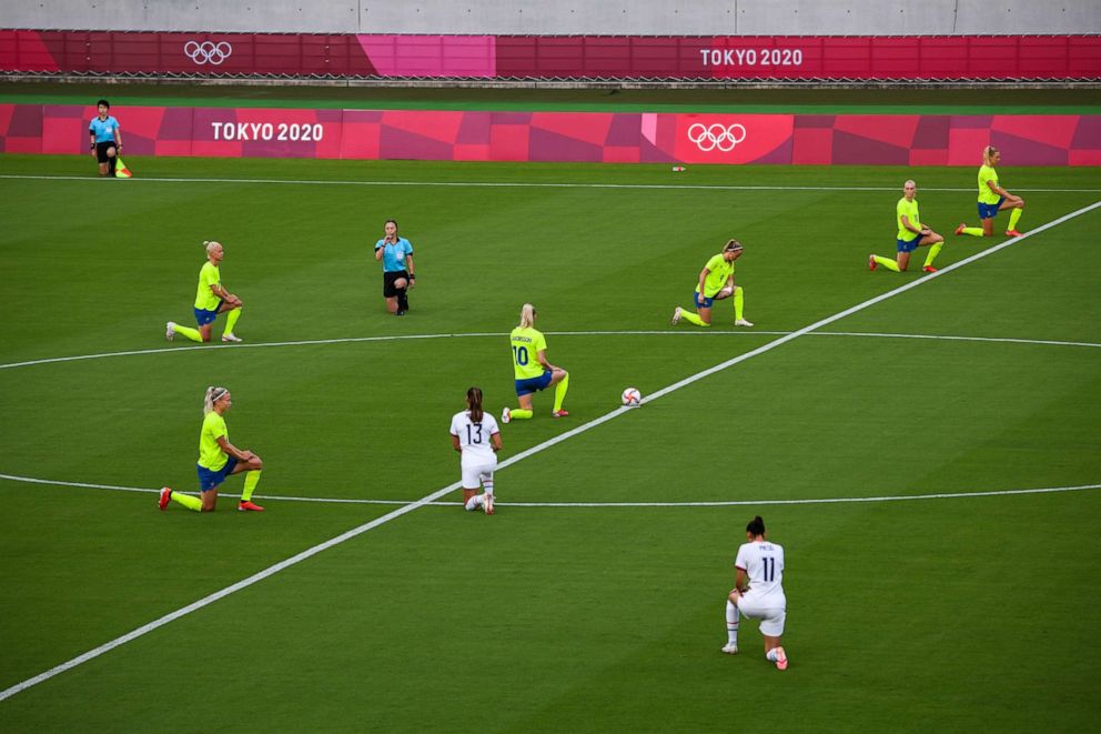 PHOTO: Players take the knee ahead of an opening round women's football match between the U.S. and Sweden at the Tokyo 2020 Olympic Games in Tokyo, Japan, on Wednesday, July 21, 2021.