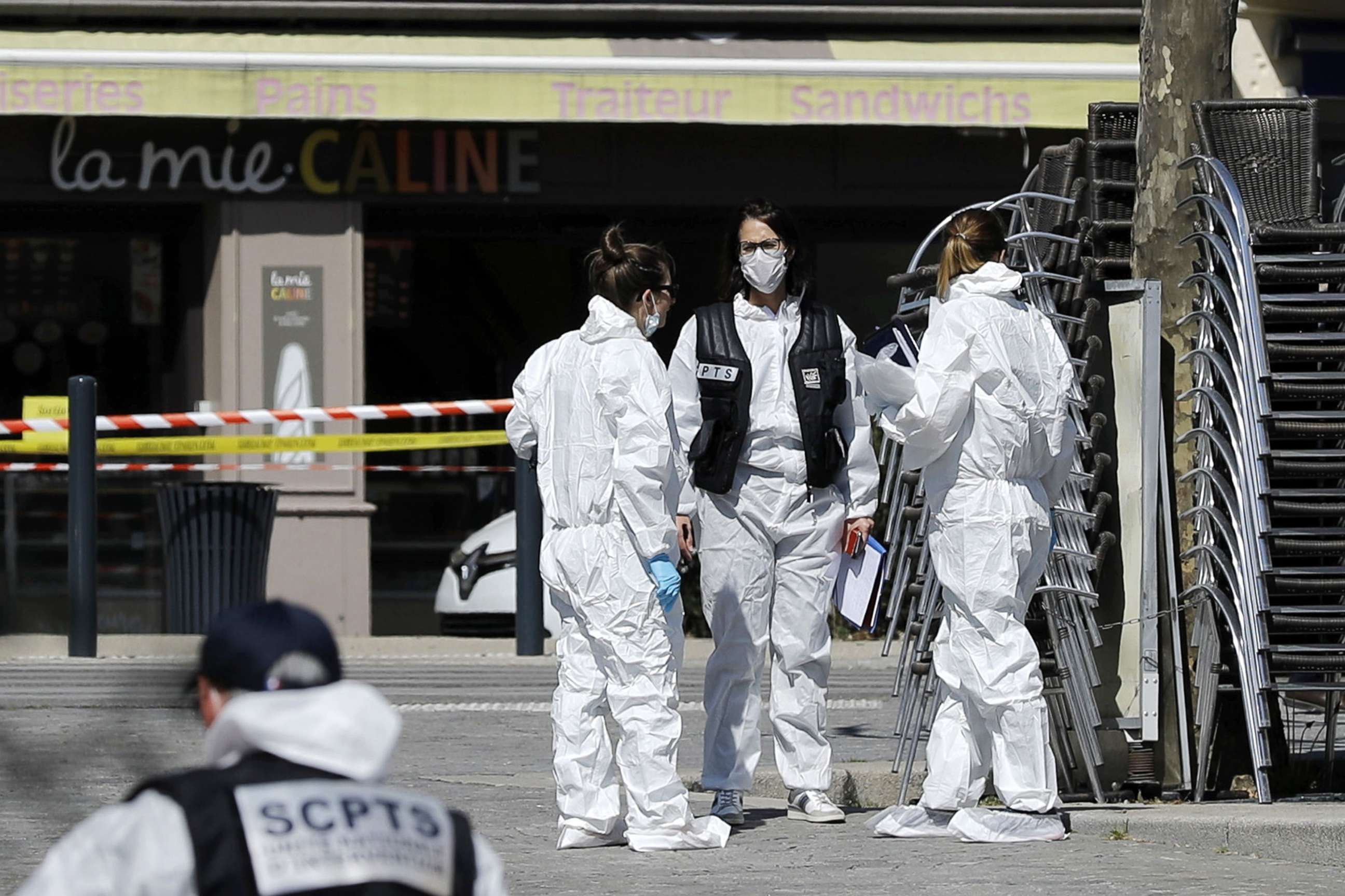 PHOTO: Police officers and investigators work on the scene of attack after a man stabbed several people in Romans-sur-Isere, France, April 4, 2020.