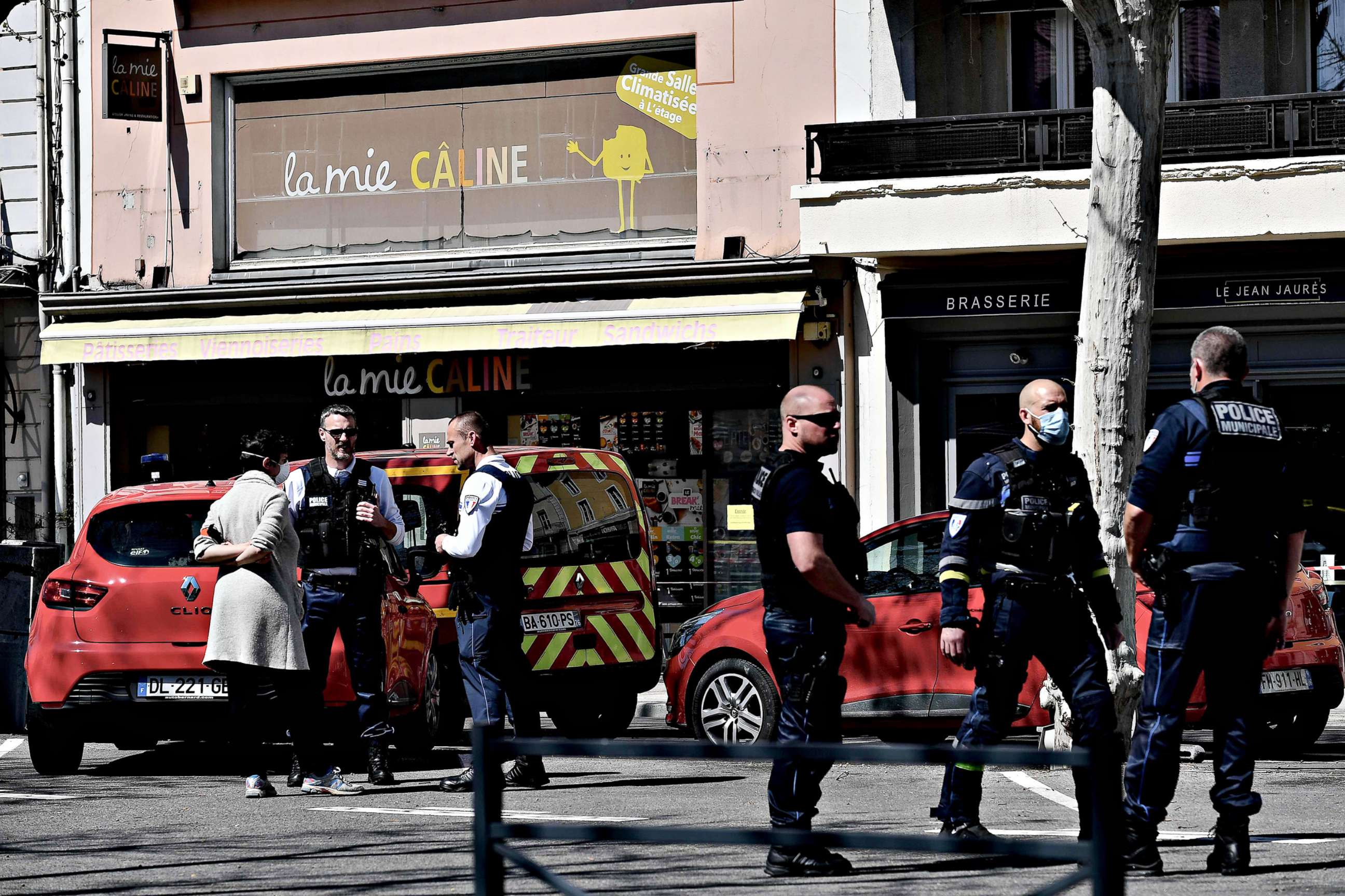 PHOTO: Police officers stand in a street in the center of Romans-sur-Isere, France, on April 4, 2020, after a man attacked several people with a knife, killing two and injuring seven before being arrested, according to sources close to the investigation.