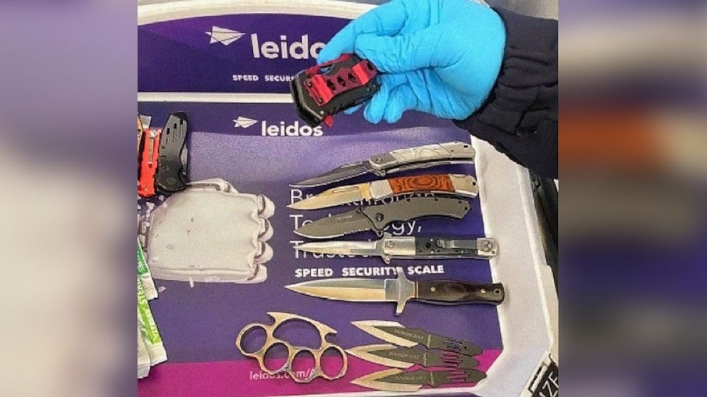 PHOTO: A TSA officer picks up a knife, one of many weapons that were detected in a traveler’s carry-on bag at Reagan National Airport (DCA) on May 4, 2022, in Arlington, Va.