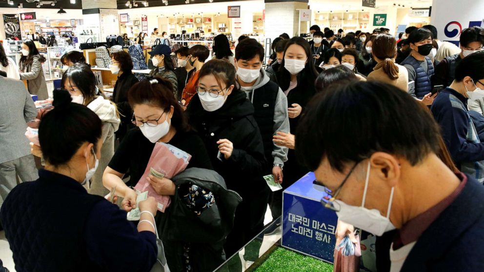 PHOTO: People wearing masks to prevent contracting the coronavirus wait in line to buy masks at a department store in Seoul, South Korea, Feb. 27, 2020.    