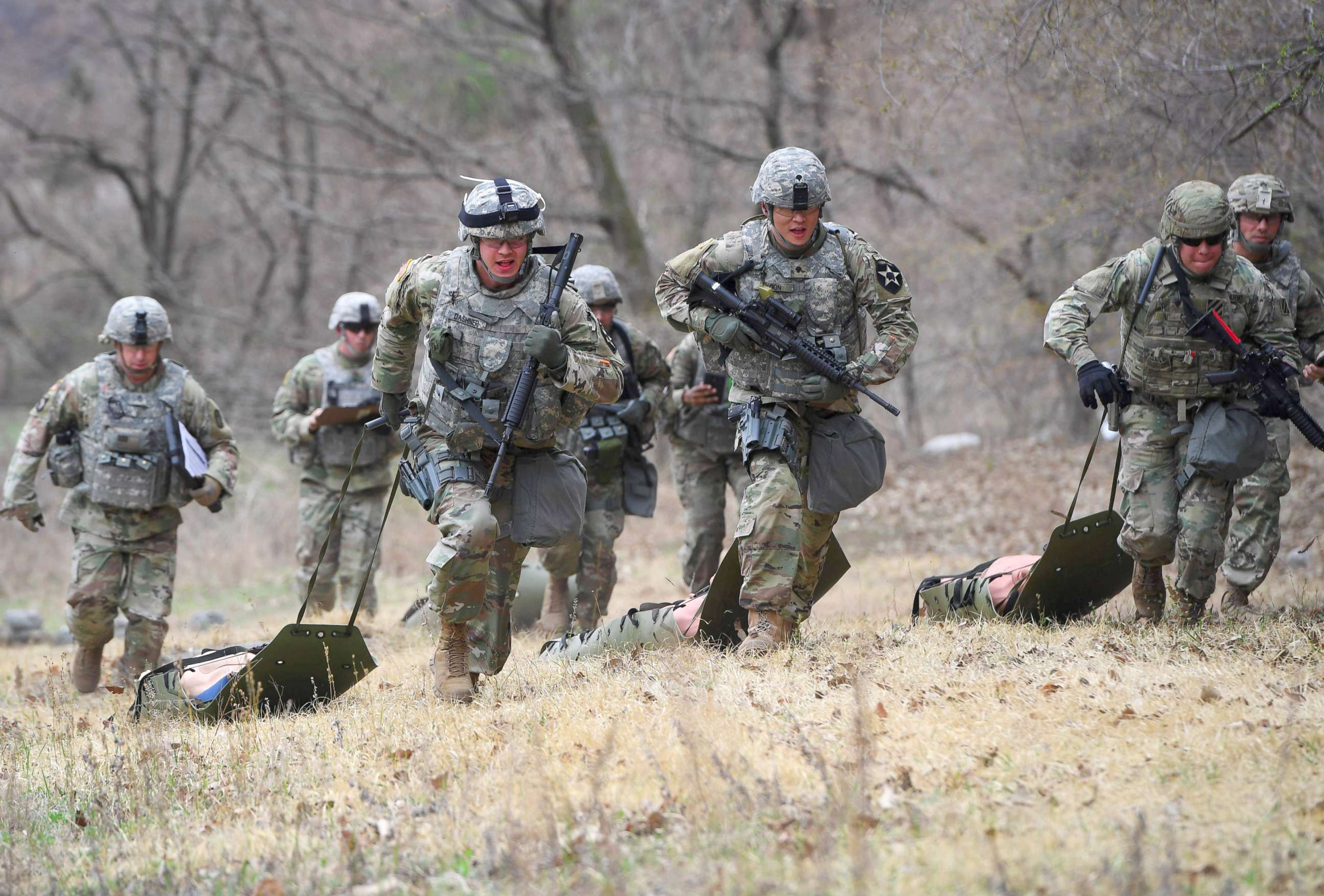 PHOTO: U.S. soldiers run with dummy's during a Stress Shoot test of the 2018 Best Warrior Competition at Camp Casey in Dongducheon, north of Seoul, April 10, 2018.
