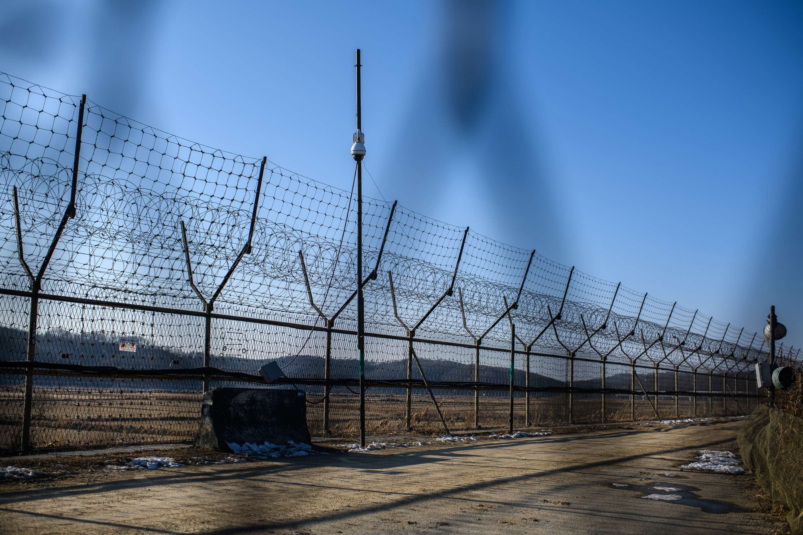 PHOTO: A barbed wire fence runs alongside the Han River near the Demilitarized Zone (DMZ) between South and North Korea, Feb, 7, 2018 near Panmunjom, South Korea.
