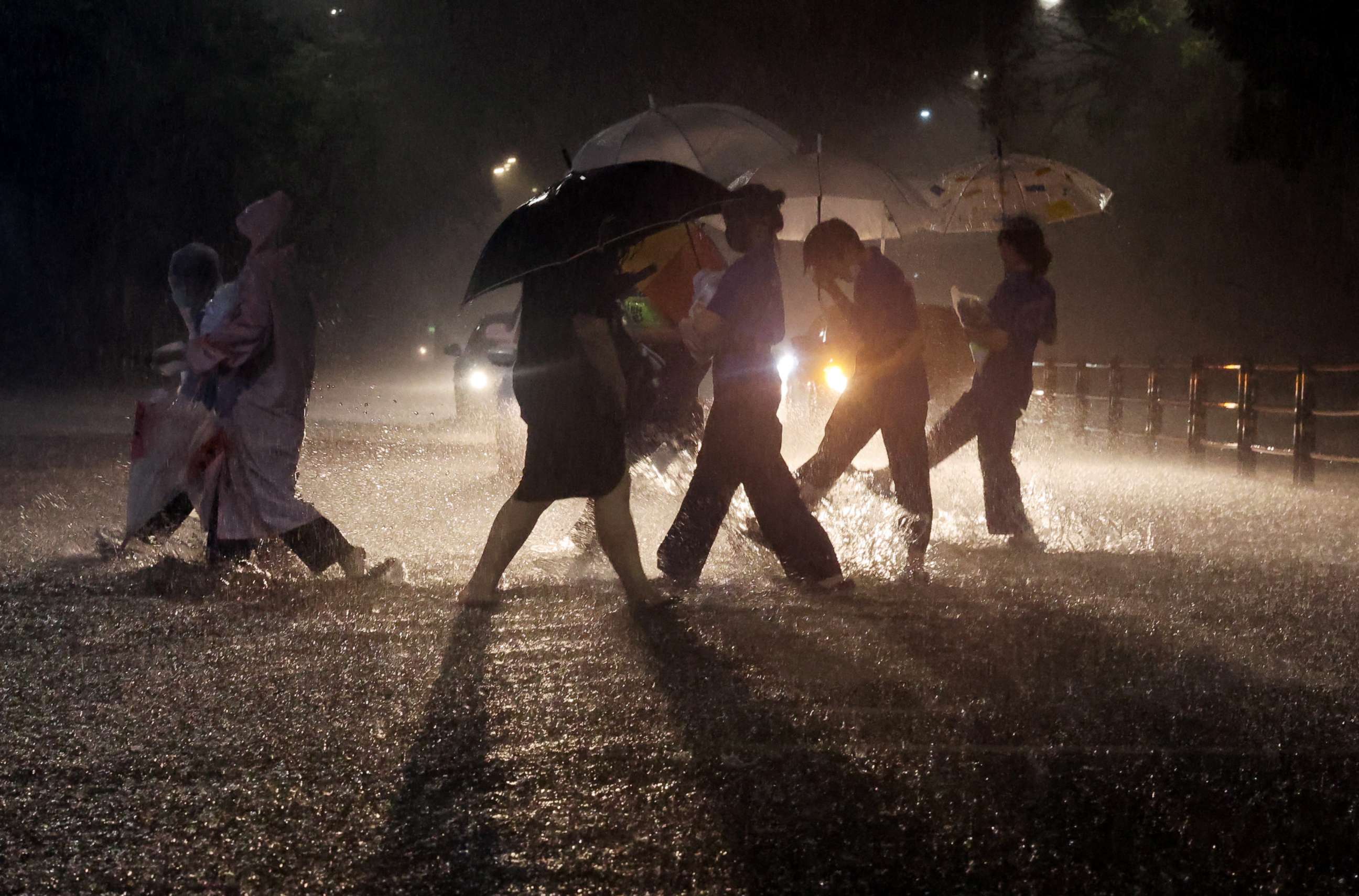 PHOTO: People walk on a zebra crossing in flooded area during heavy rain in Seoul, South Korea, Aug. 8, 2022.