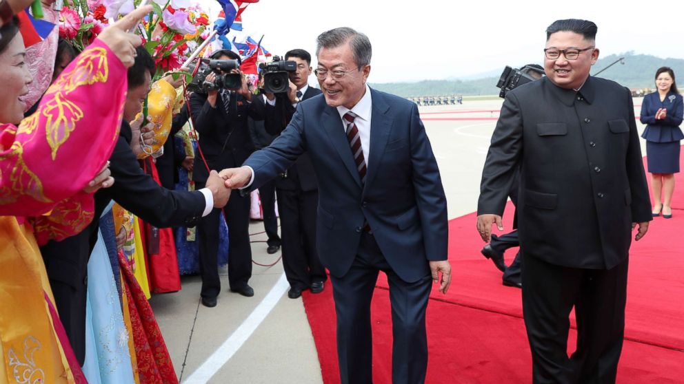 South Korean president Moon Jae-in and North Korean leader Kim Jong Un greet North Korean citizens at Sunan International Airport, Pyongyang North Korea. Sep 18, 2018. 