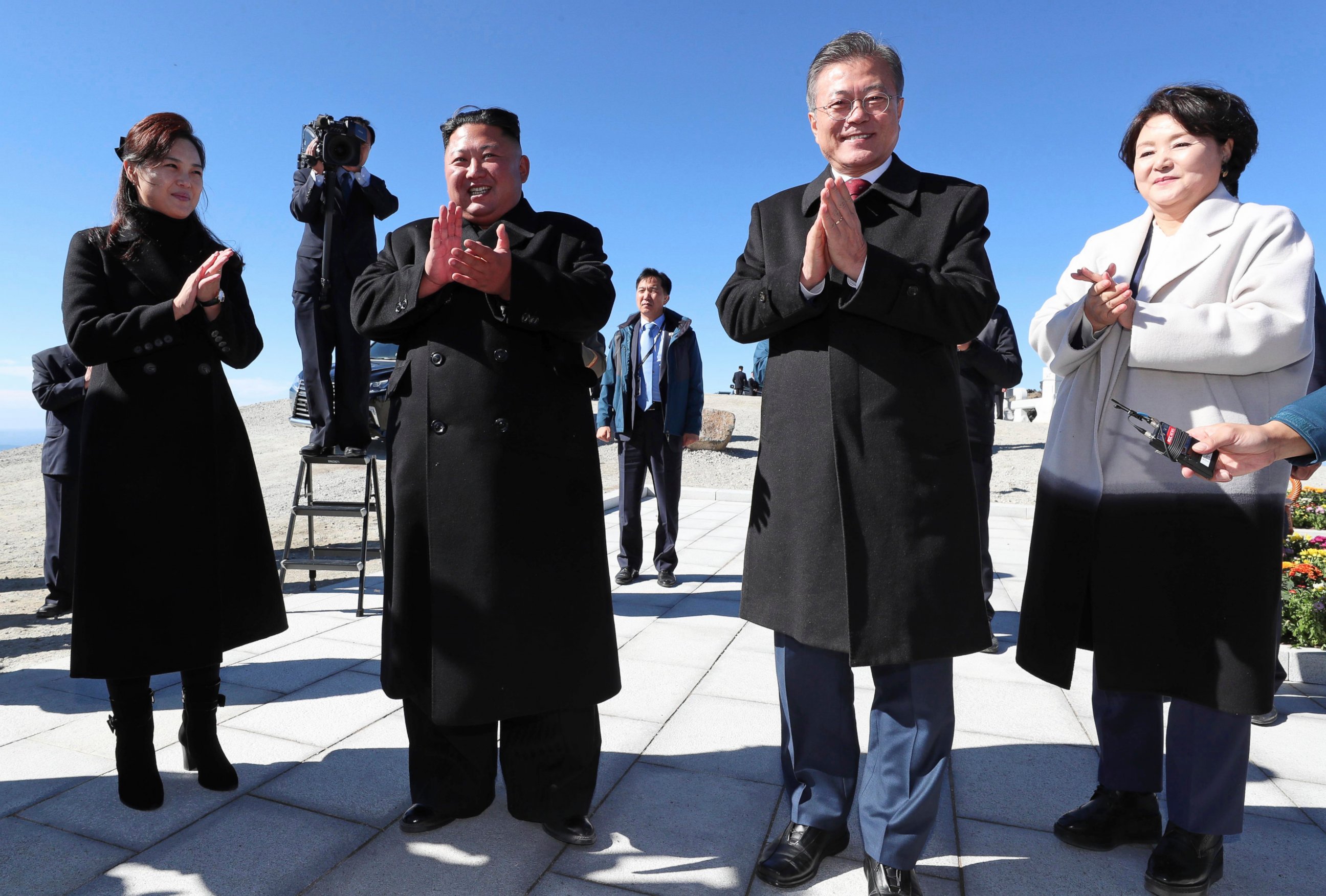 South Korean President Moon Jae-in, second from right, his wife Kim Jung-sook, right, North Korean leader Kim Jong Un, second from left, and his wife Ri Sol Ju clap hands on the Mount Paektu in North Korea on Thursday.