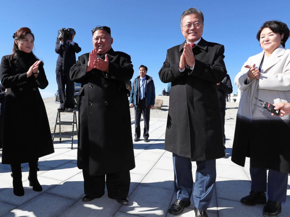 South Korean President Moon Jae-in, second from right, his wife Kim Jung-sook, right, North Korean leader Kim Jong Un, second from left, and his wife Ri Sol Ju clap hands on the Mount Paektu in North Korea on Thursday.