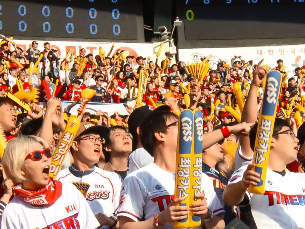 PHOTO: In Seoul, baseball fans wear team uniforms and wave balloon sticks in support of their team.