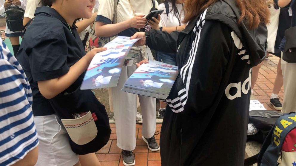 PHOTO: Passionate EXO fans hand out slogans and pictures of the idol boy band for free in front of the concert venue in Seoul, South Korea. 