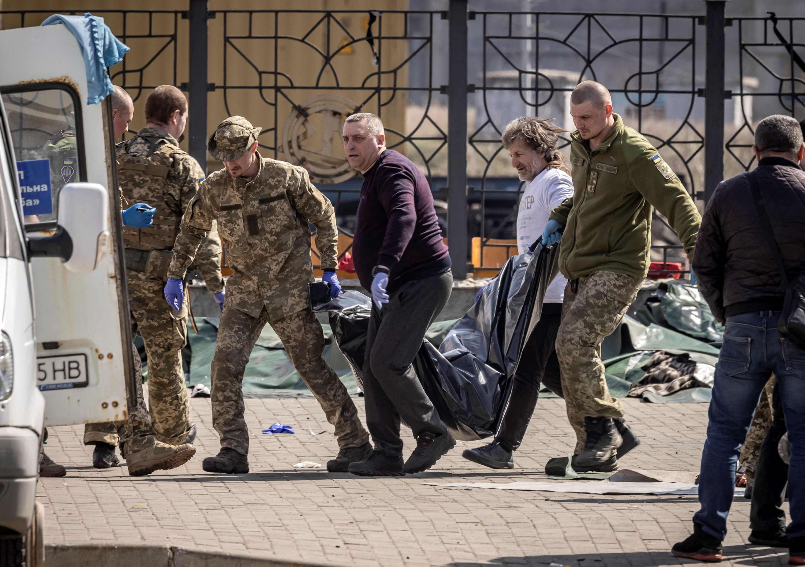PHOTO: Soldiers clear out bodies after a rocket attack killed many people on Friday, April 8, 2022, at a train station in Kramatorsk, eastern Ukraine, being used for civilian evacuations.