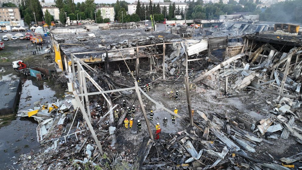 PHOTO: This handout picture taken and released by State Emergency Service of Ukraine on June 28, 2022, shows rescuers working in the wreckages of a mall in Kremenchuk, the day after it was hit by a Russian missile strike.