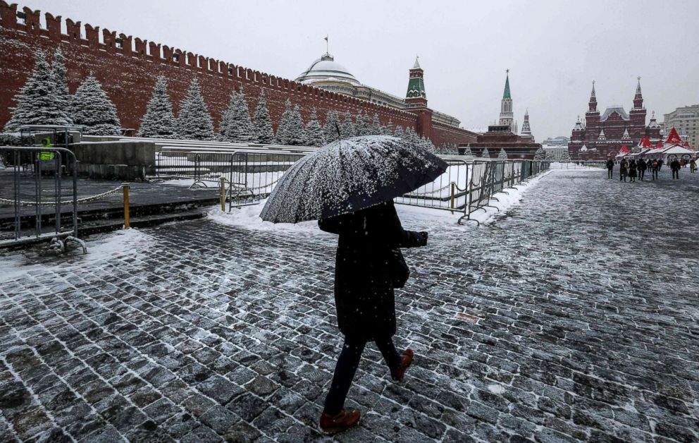 PHOTO: A woman walks on Red Square past the Kremlin after a night of heavy snowfall in Moscow, Dec. 6, 2018.