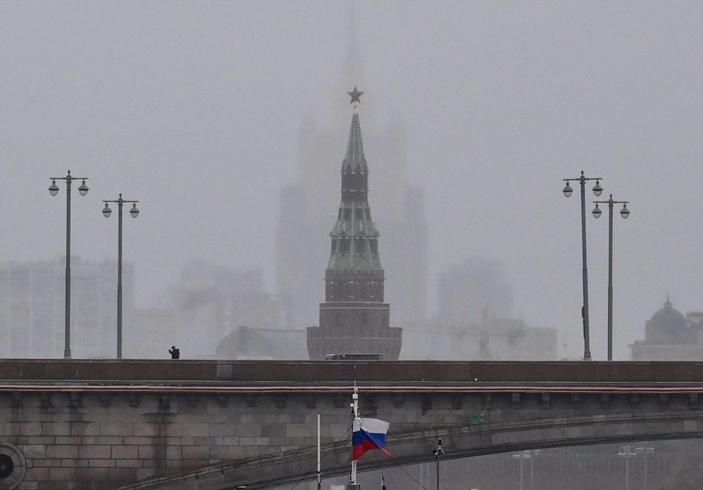 PHOTO: A pedestrian walks along a bridge in front of the Vodovzvodnaya tower of the Kremlin and the Russian Foreign Ministry headquarters in central Moscow on Oct. 4, 2022.