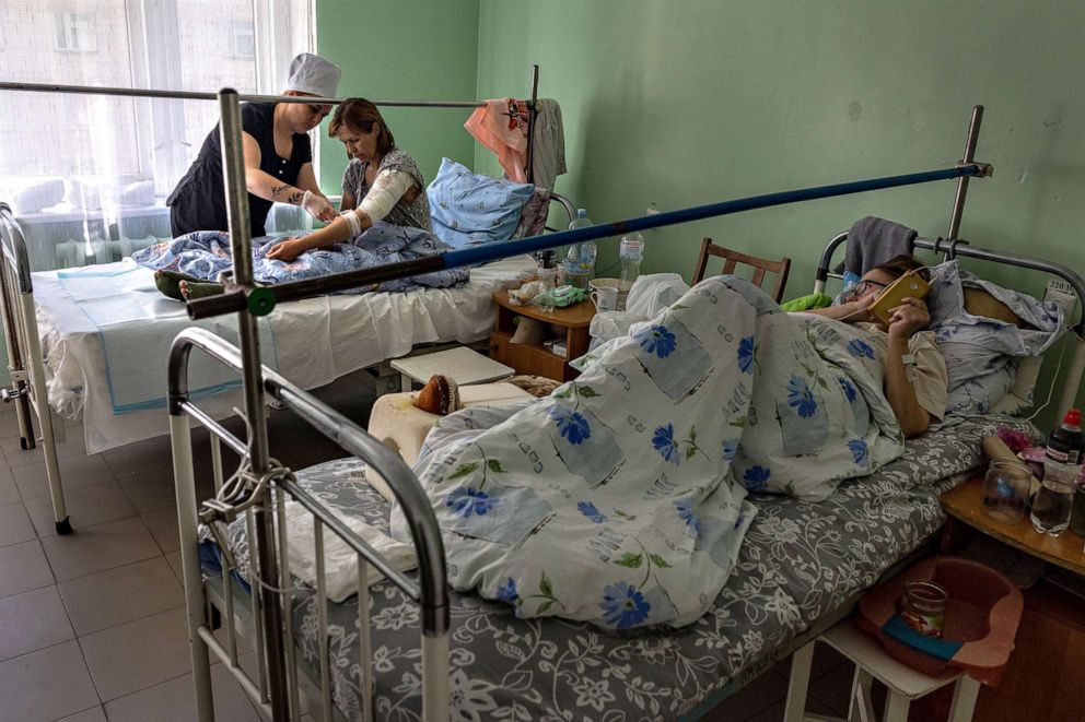 PHOTO: A nurse checks the wounds of Ponomareva Natalia Sergiivna, 41, three days after her family's home was shelled by Russian forces in their frontline village of Vysokopilla in the Kherson region of southern Ukraine on May 05, 2022.