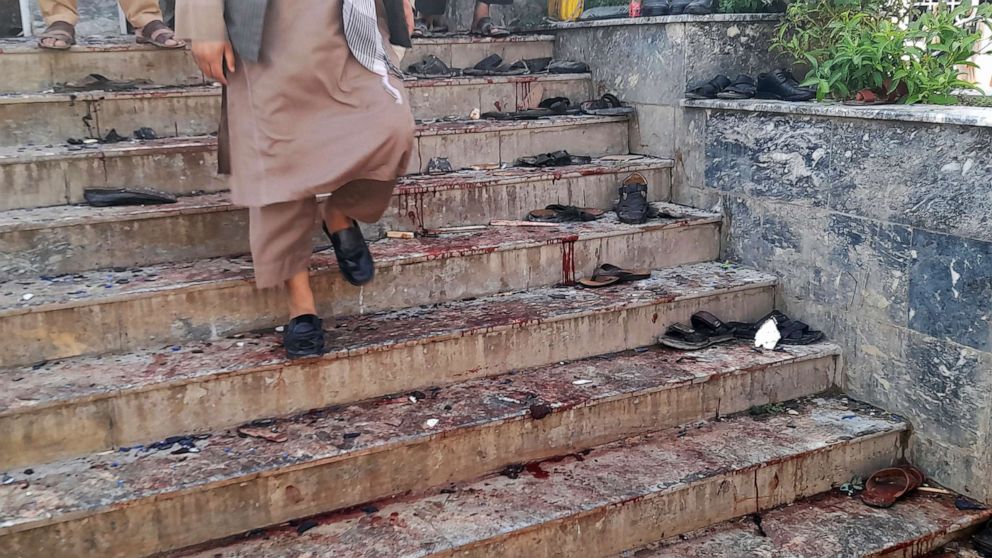 PHOTO: A man walks down blood-stained steps of a mosque following a bombing in Kunduz province, northern Afghanistan, Oct. 8, 2021.