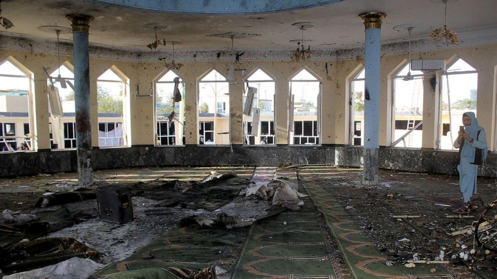 PHOTO: An Afghan man films inside a mosque after a blast, in Kunduz, Afghanistan, Oct. 8, 2021.