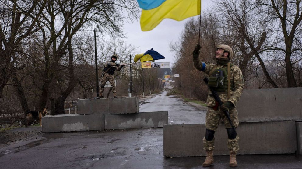 PHOTO: Ukrainian soldiers celebrate at a check point in Bucha, on the outskirts of Kyiv, Ukraine, April 3, 2022.