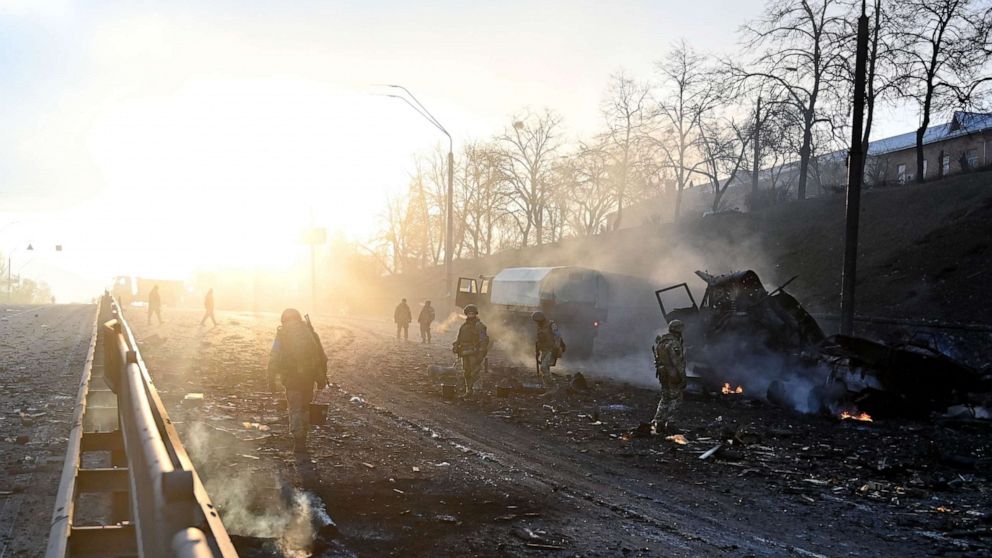 PHOTO: Ukrainian service members look for and collect unexploded shells after a fighting with Russians in Kyiv in the morning, Feb. 26, 2022.