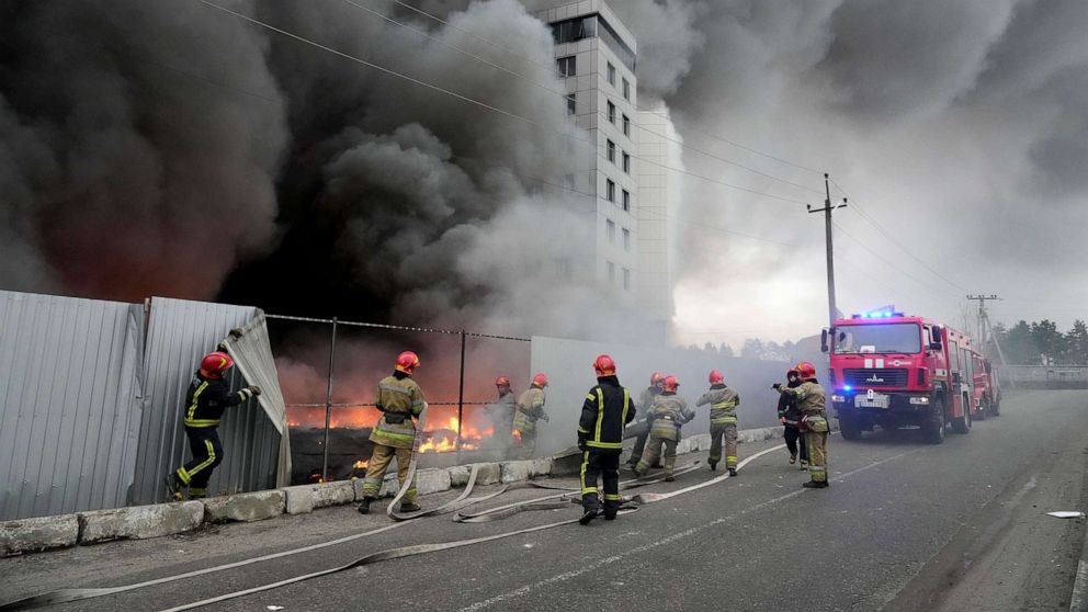 PHOTO: Firefighters work to extinguish a fire at a damaged logistic center after shelling in Kyiv, Ukraine, March 3, 2022. 