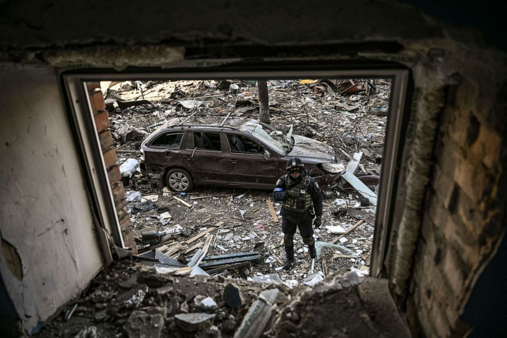 PHOTO: A Ukranian soldier walks in a residential area  after shelling in Kyiv on March 18, 2022.