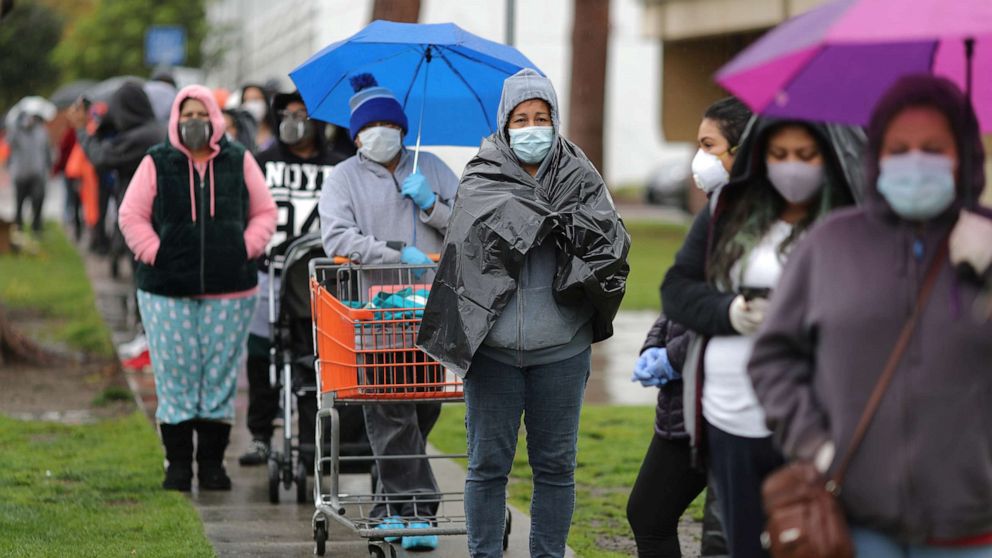 PHOTO: People queue to pick up fresh food at a Los Angeles Regional Food Bank giveaway of 2,000 boxes of groceries, as the spread of the coronavirus disease (COVID-19) continues, in Los Angeles, April 9, 2020.