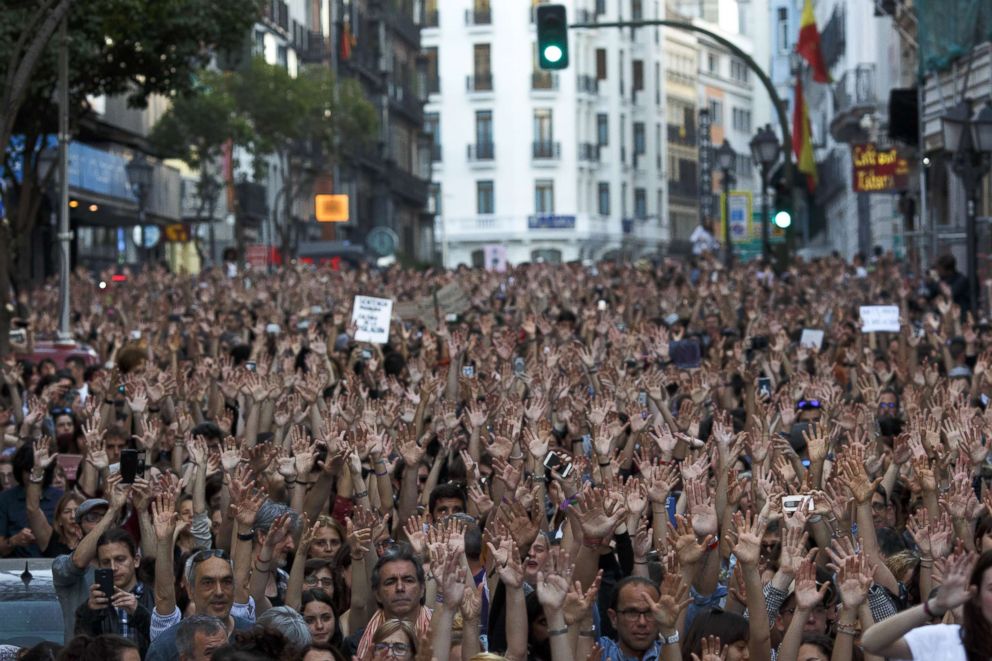 PHOTO: Protesters rise their hands as they demonstrate against the verdict of 'La Manada' (Wolf Pack) gang case outside the Minister of Justice, April 26, 2018, in Madrid.
