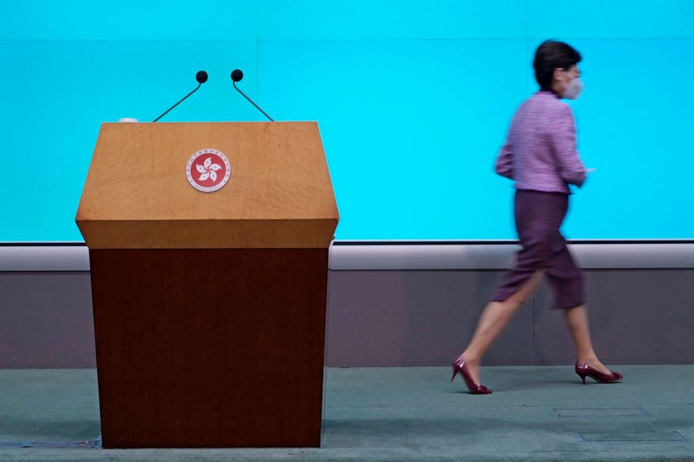 PHOTO: Hong Kong Chief Executive Carrie Lam leaves after a news conference in Hong Kong, Monday, April 4, 2022.