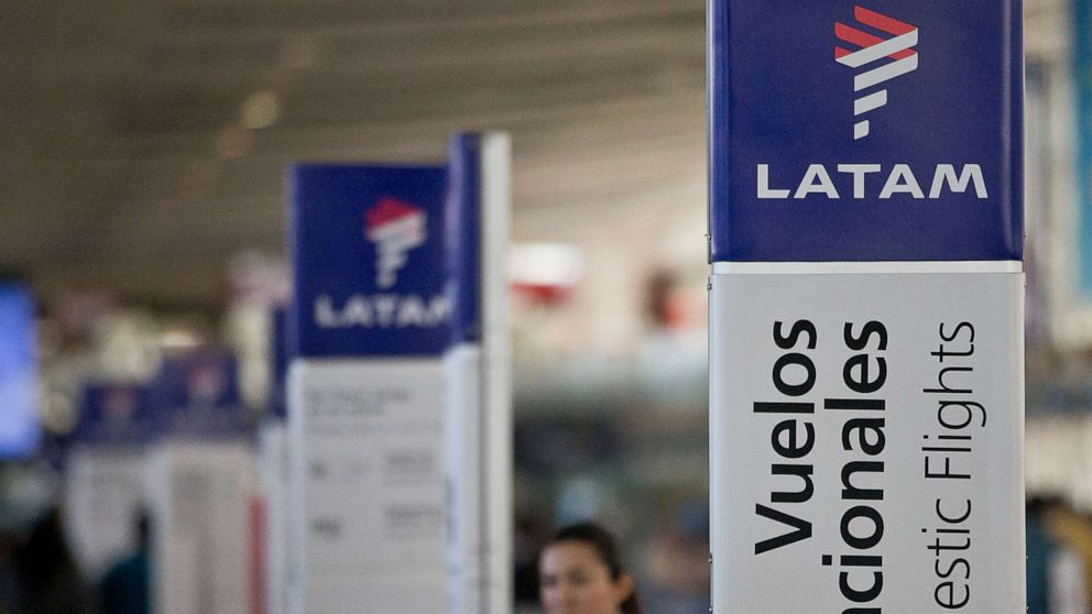 PHOTO: In this file photo taken on July 25, 2016, an agent of LATAM Airlines stands by the counters at the airport in Santiago, Chile.