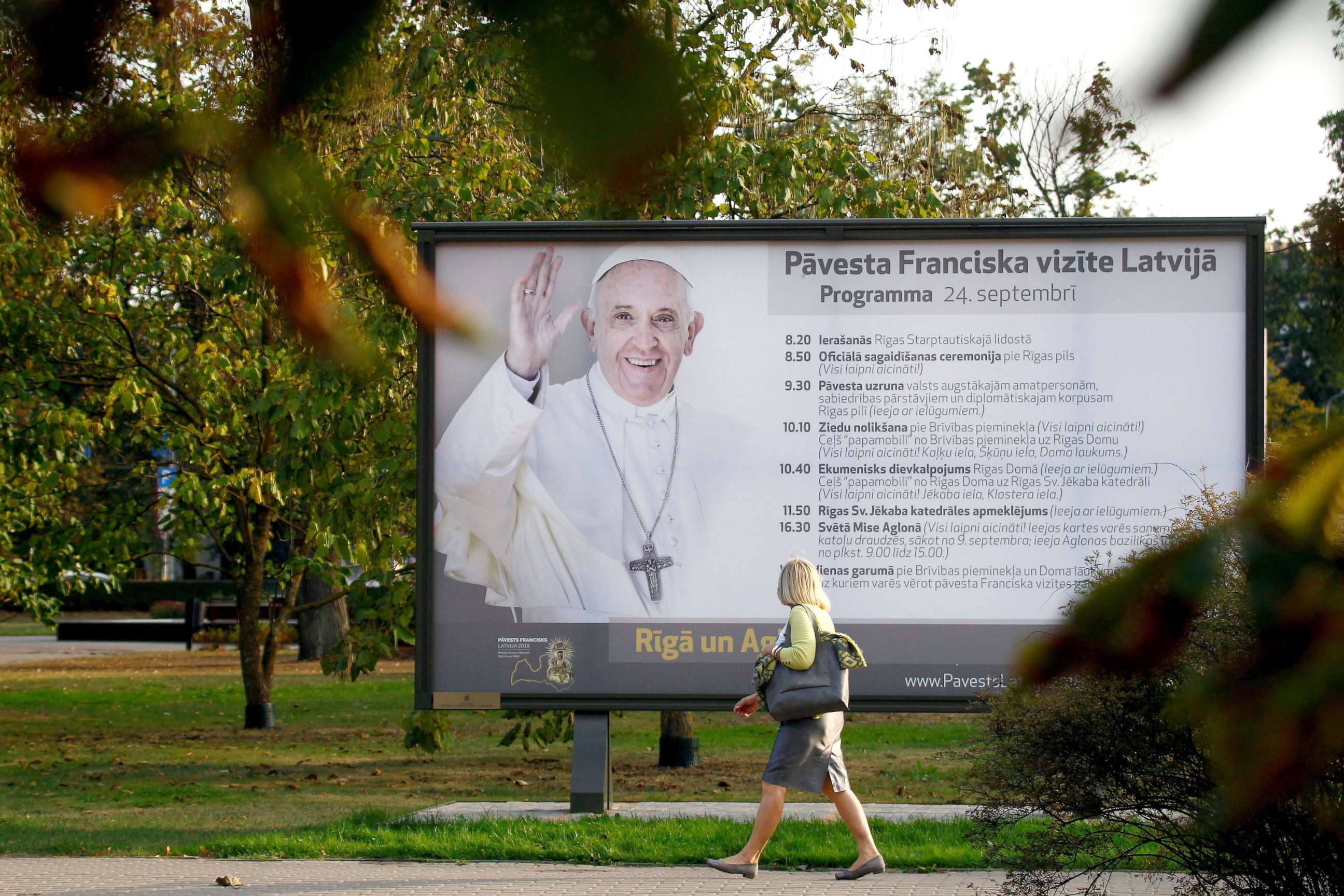 PHOTO: A woman walks next to a billboard advert of Pope Francis upcoming visit to Latvia, in Riga, Latvia, Sept. 20, 2018.