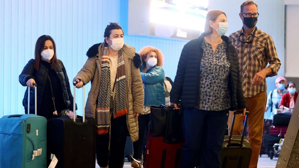 PHOTO: International travelers pass through the Tom Bradley International Terminal after arriving into the U.S. at Los Angeles International Airport (LAX) on Dec. 01, 2021, in Los Angeles.