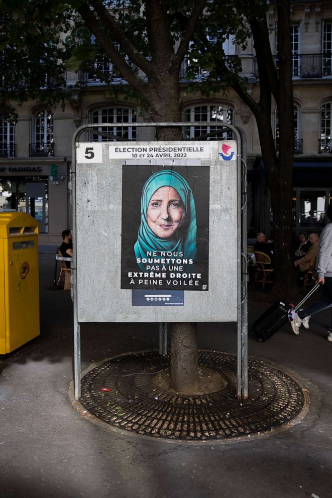 PHOTO: A poster of French far right party presidential candidate Marine Le Pen, drawn with a headscarf to denounce her Islamophobic policy, especially against the wearing of the veil for Muslim women in public space, is shown in Paris on April 22, 2022.