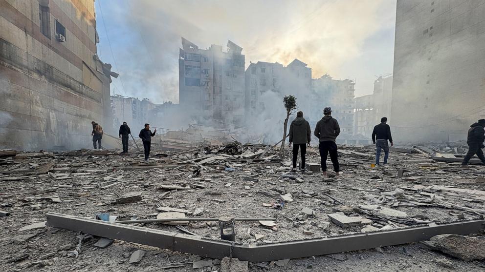PHOTO: People stand on the rubble of a damaged building after an Israeli strike on Beirut's southern suburbs, following renewed hostilities between Hezbollah and Israel amid the U.S.-Israeli conflict with Iran, in Beirut, Lebanon, March 6, 2026.