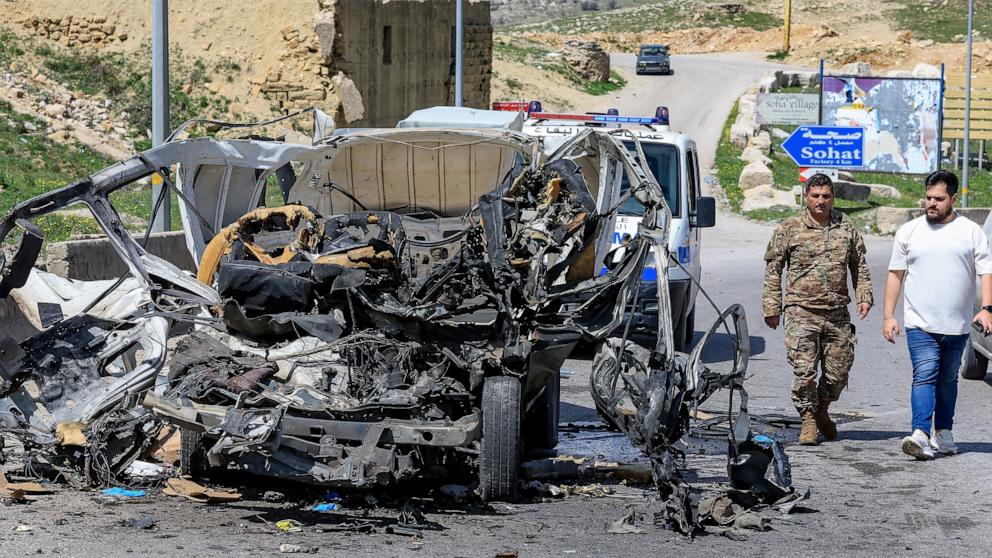 PHOTO: A member of the Lebanese army and a man walk at the site of an Israeli strike on a vehicle in Dahr el Baydar, Lebanon April 16, 2026. 