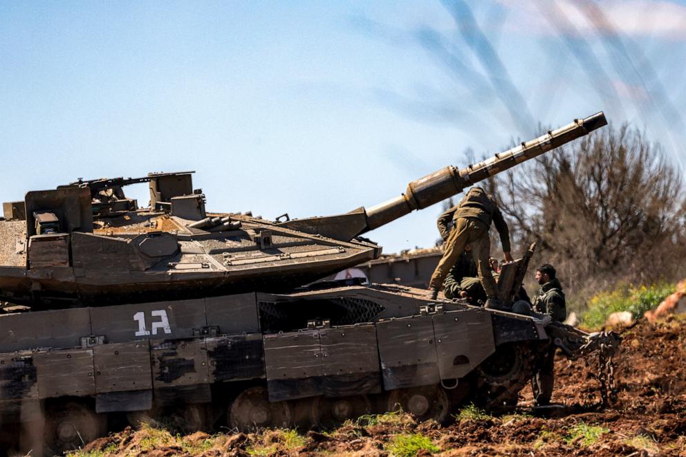 PHOTO: An Israeli army soldier stands on a Merkava main battle tank deployed at a position in the upper Galilee in northern Israel near the Lebanon border on March 9, 2026.