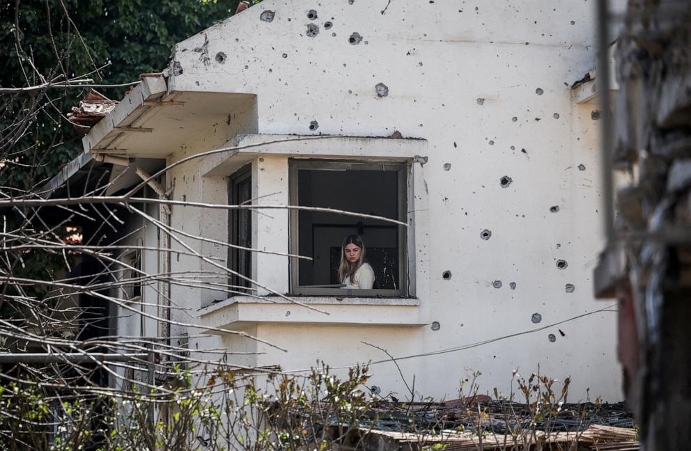 PHOTO: A woman looks out from a damaged house, following projectile barrages towards Israel from Iran-backed Hezbollah in Lebanon, amid an escalation between Hezbollah and Israel and the U.S.-Israeli conflict with Iran, in central Israel, March 12, 2026.