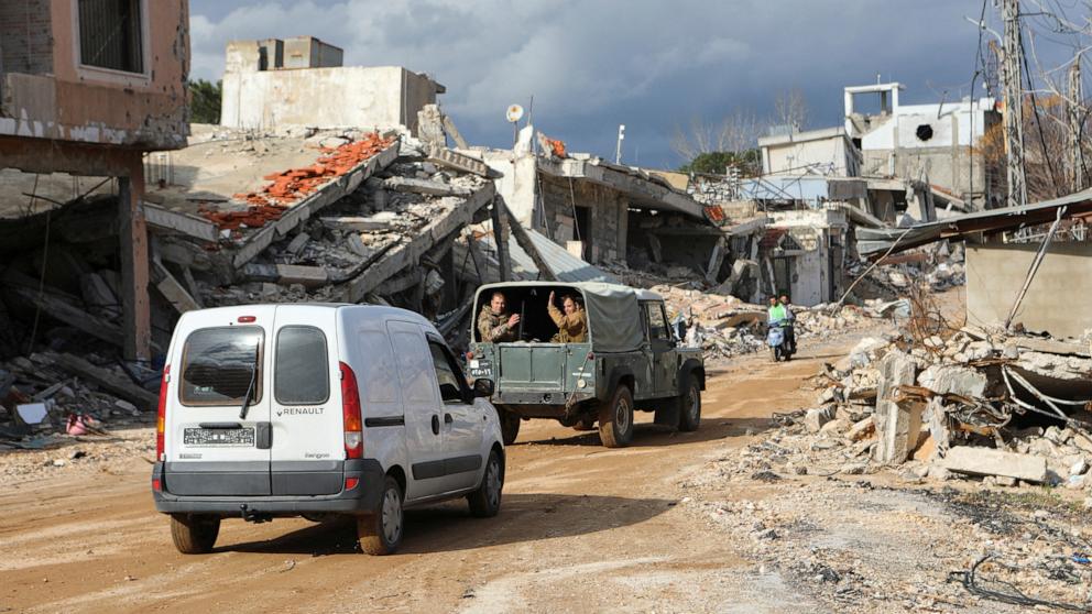 PHOTO: Lebanese army members gesture as they drive through a damaged site at the Lebanese village of Khiam, near the border with Israel, southern Lebanon, Jan. 23, 2025.