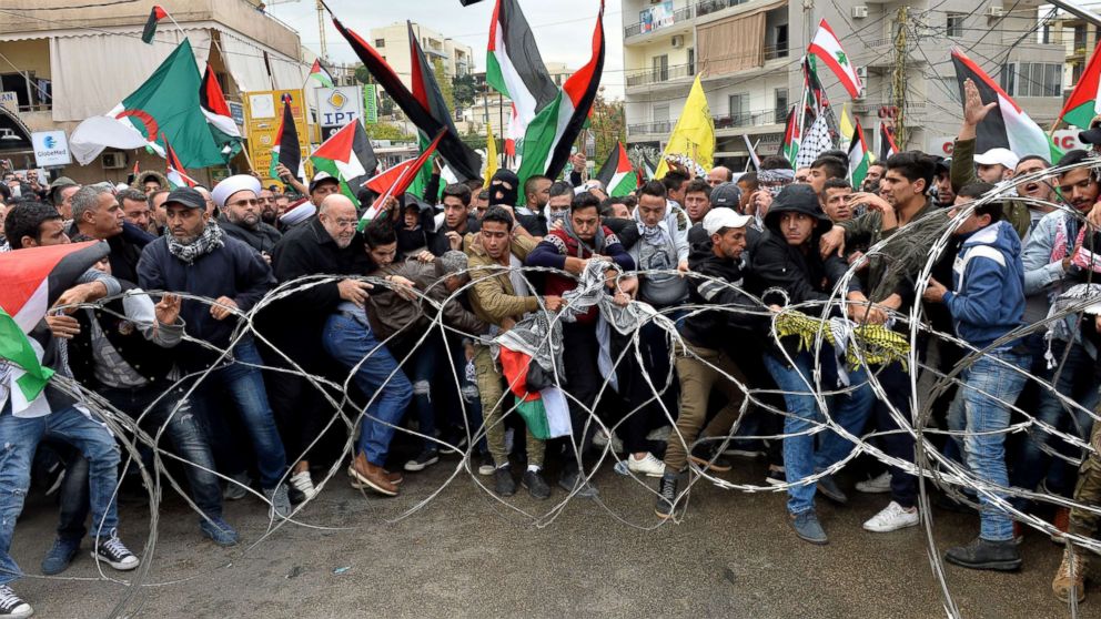 PHOTO: Protesters try to remove barbed wires that block a road near the U.S. embassy during a protest against President Donald Trump's decision to recognize Jerusalem as the Capital of Israel, in Awkar, east of Beirut, Lebanon, Dec. 10, 2017.