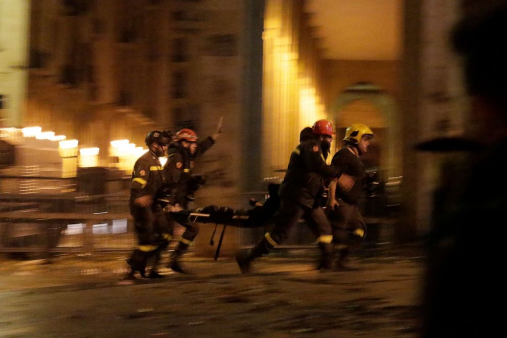 PHOTO: Civil defense workers carry an anti-government protester who was injured while clashing with riot police, during ongoing protests against the political elites who have ruled the country for decades, in Beirut, Jan. 19, 2020.