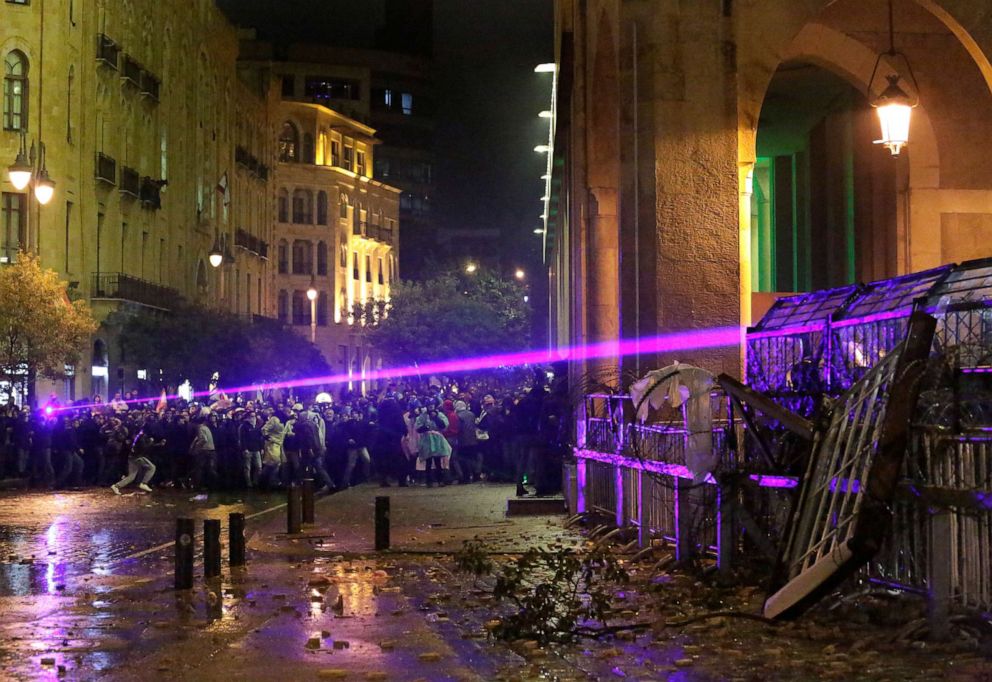 PHOTO: Anti-government protesters use their Laser ray lights as they clash with the riot police, during ongoing protests against the political elites who have ruled the country for decades, in Beirut, Jan. 19, 2020.